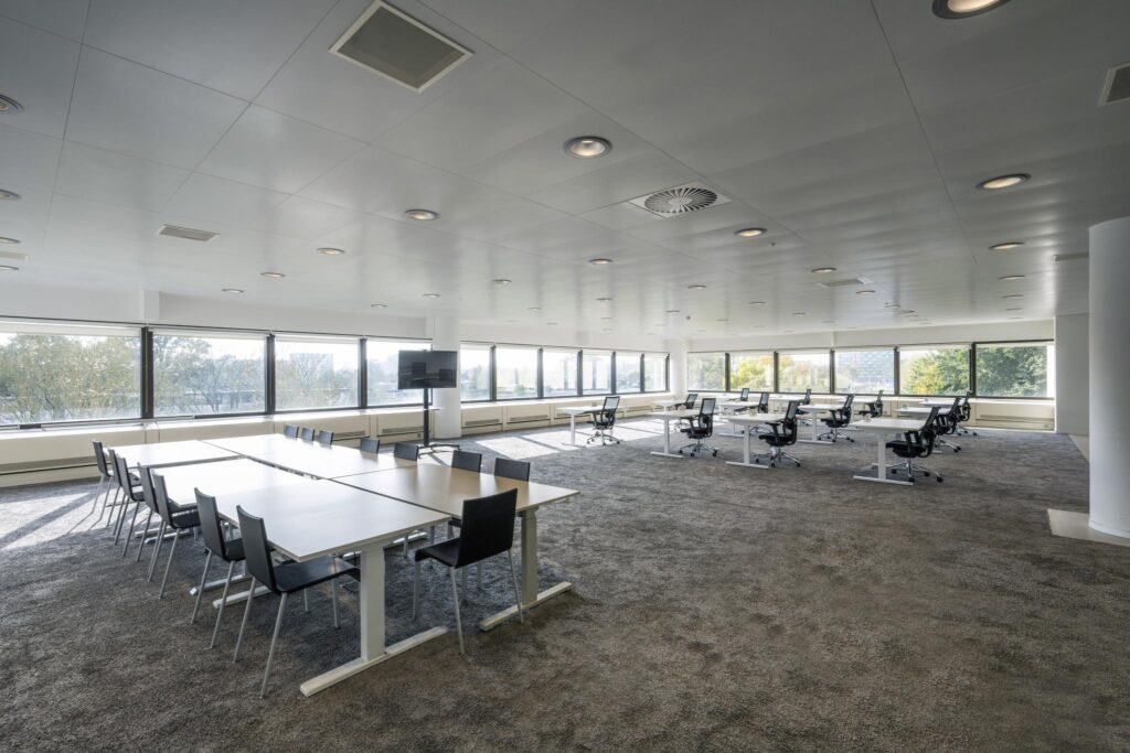 Spacious modern office area with large windows, multiple desks, and conference seating on Prof. E.M. Meijerslaan.